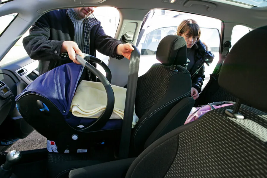 put sheets under a car seat for easy clean up