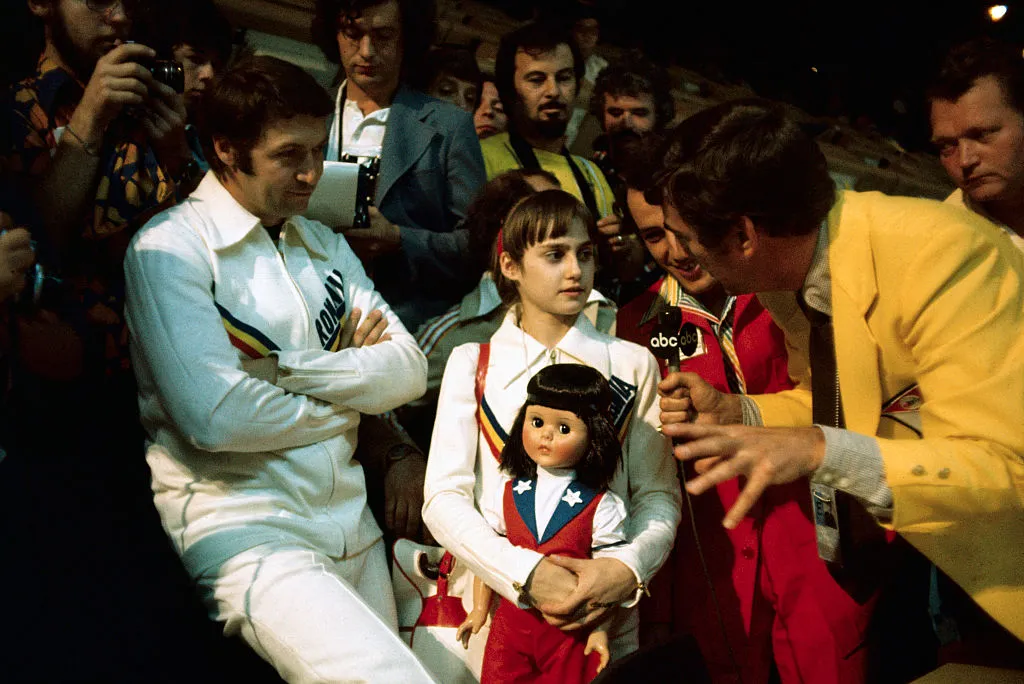 nadia comaneci with press after seven olympic perfect scores