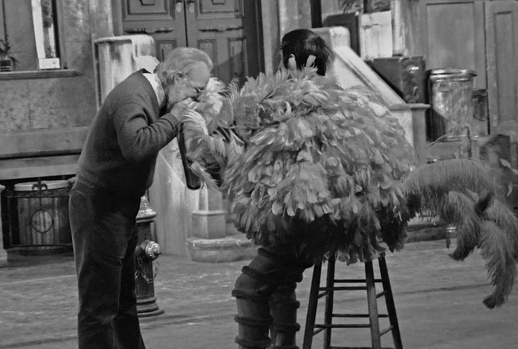 Puppeteer Caroll Spinney in his 'Big Bird' costume has an adjustment made during rehearsals for an episode of Sesame Street