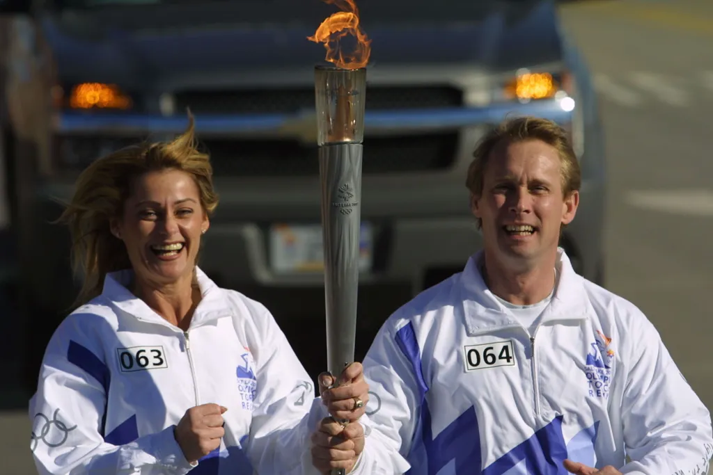 nadia comaneci and bart conner olympic torch