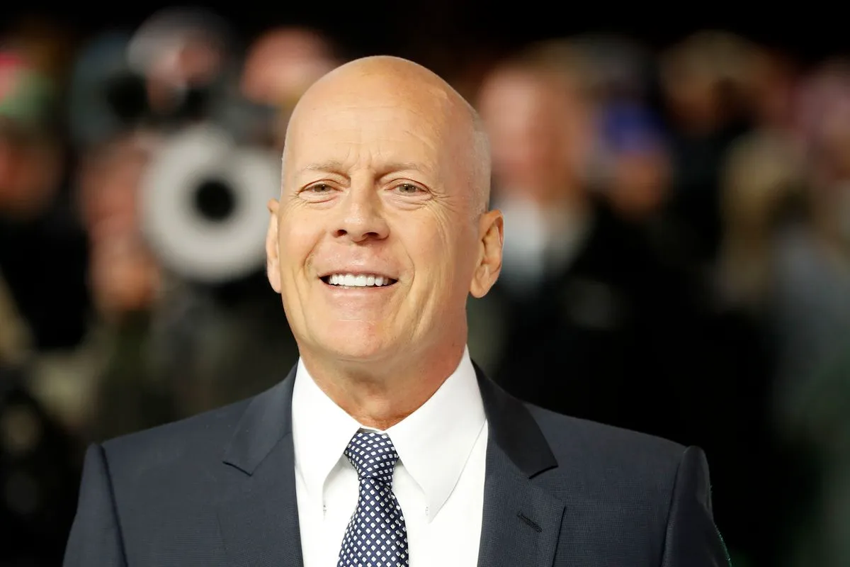 bruce willis smiling in a suit