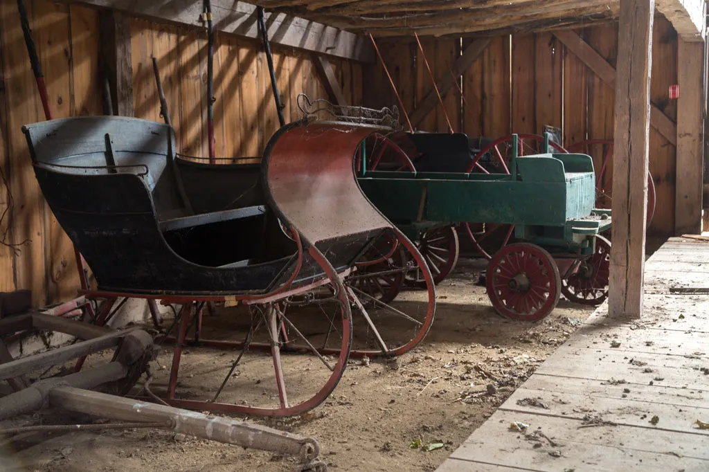 sleigh and tractor in the barn