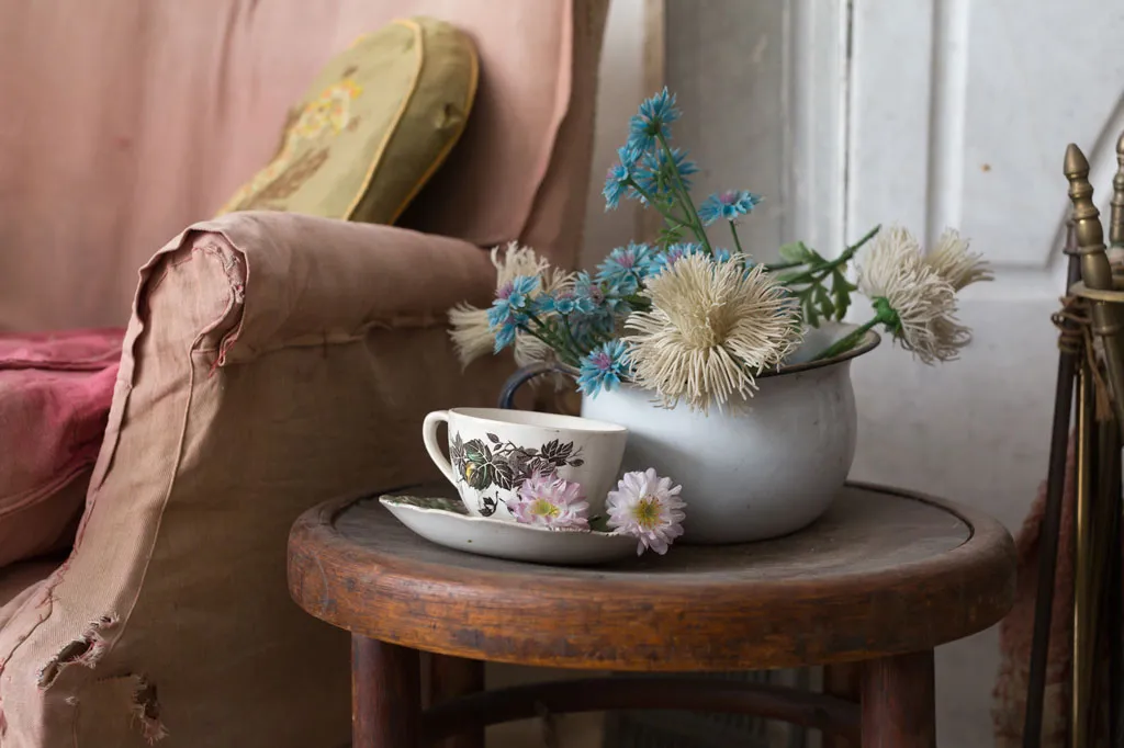 teacup and floral arrangement on table