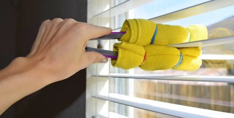 use tongs with cloth to clean blinds