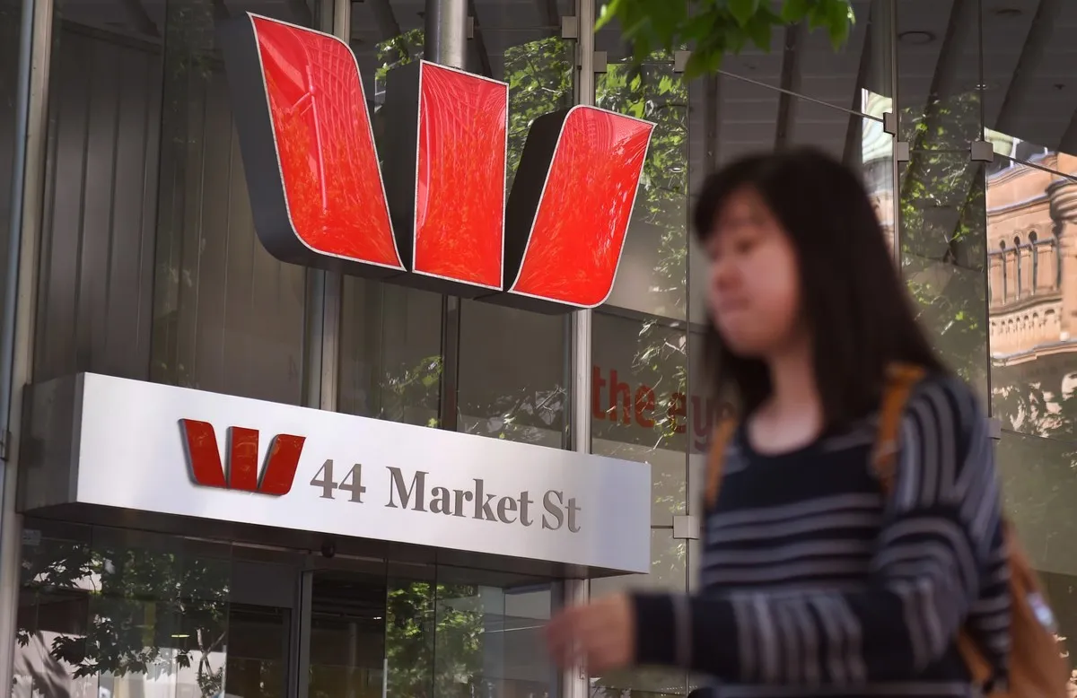 a woman walks by a westpac bank in central sydney