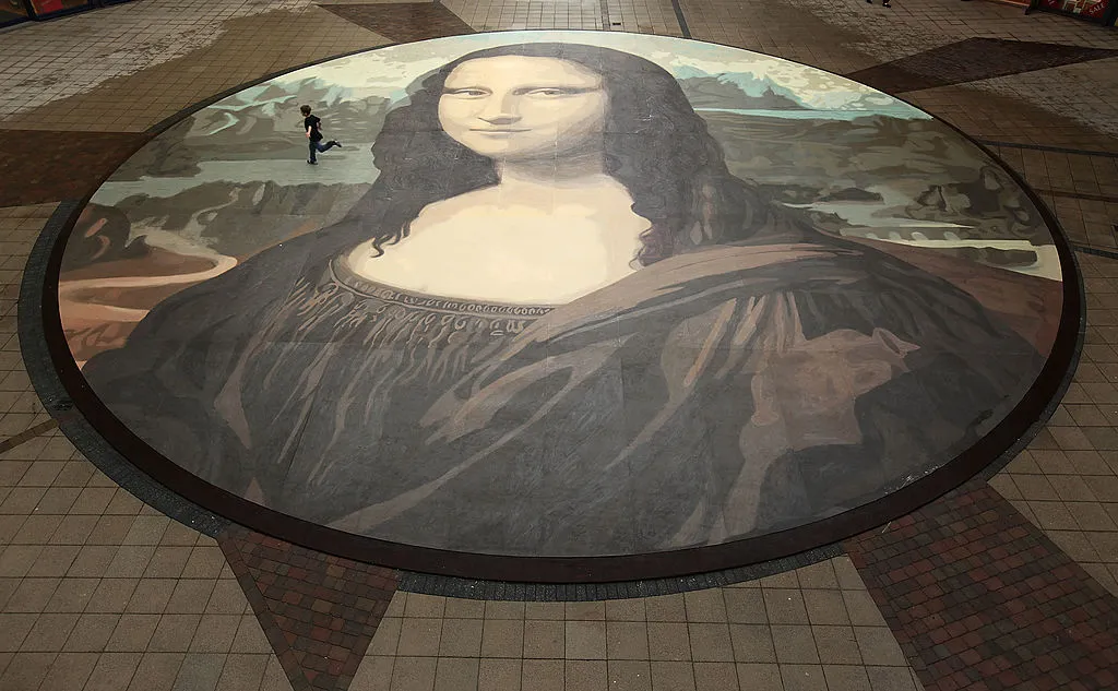  Luke Wharton-Jones, aged eight, runs across the world's biggest copy of the Mona Lisa during a photocall for its unveiling on October 28, 2009 in Wrexham, Wales