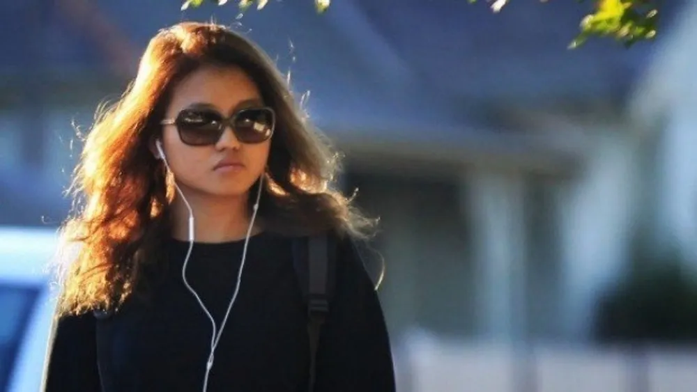 christine lee leaves the courthouse with shades and headphones