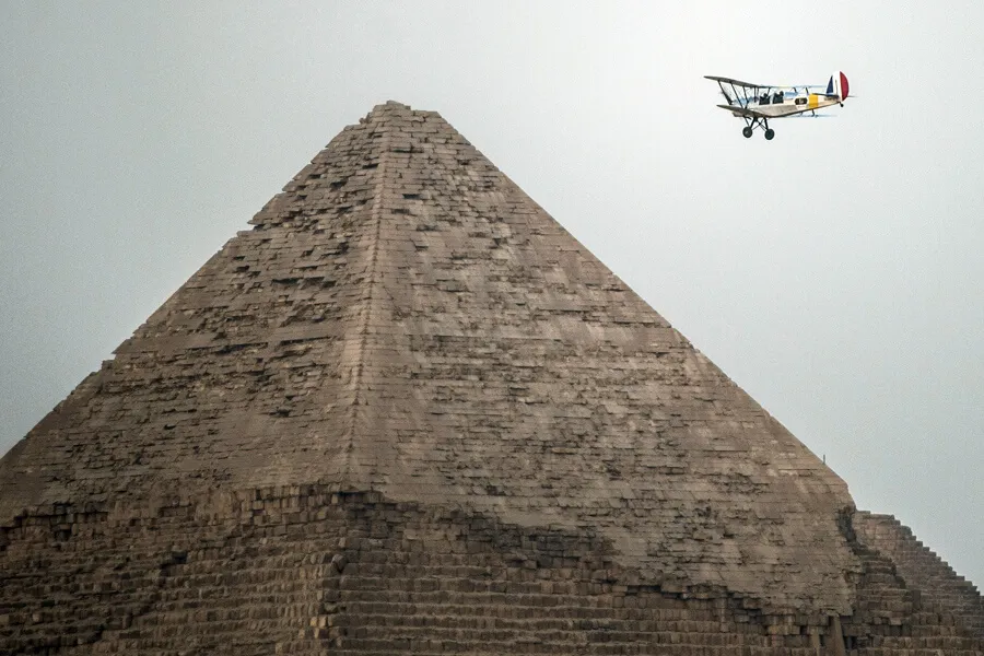 plane-flying-over-the-great-pyramid-cloudy