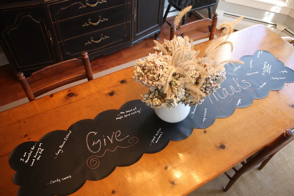 Chalkboard table runner laid out on a Thanksgiving table