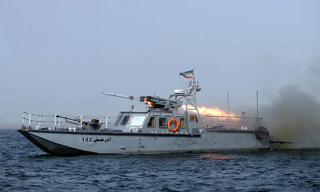 An Iranian war-boat fires a missile during the 