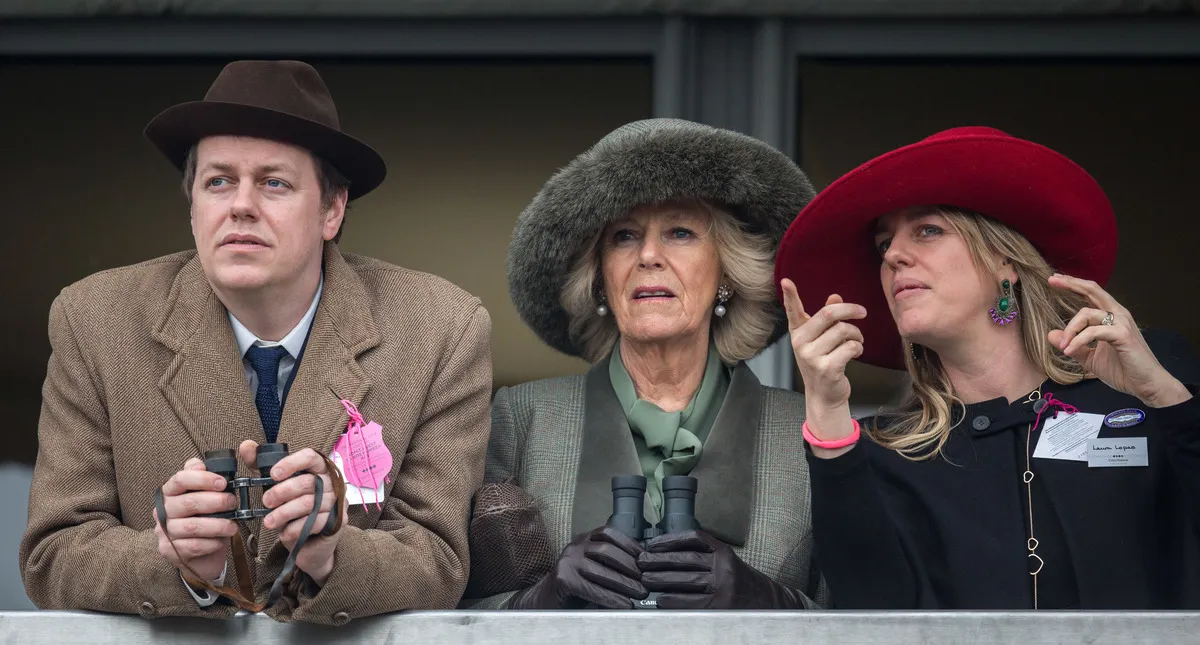 Camilla, Duchess of Cornwall (C) watches a race from the temporary Royal Box with her son Tom Parker Bowles and daughter Laura Lopes on the second day of the Cheltenham Festival on March 11, 2015 in Cheltenham, England.