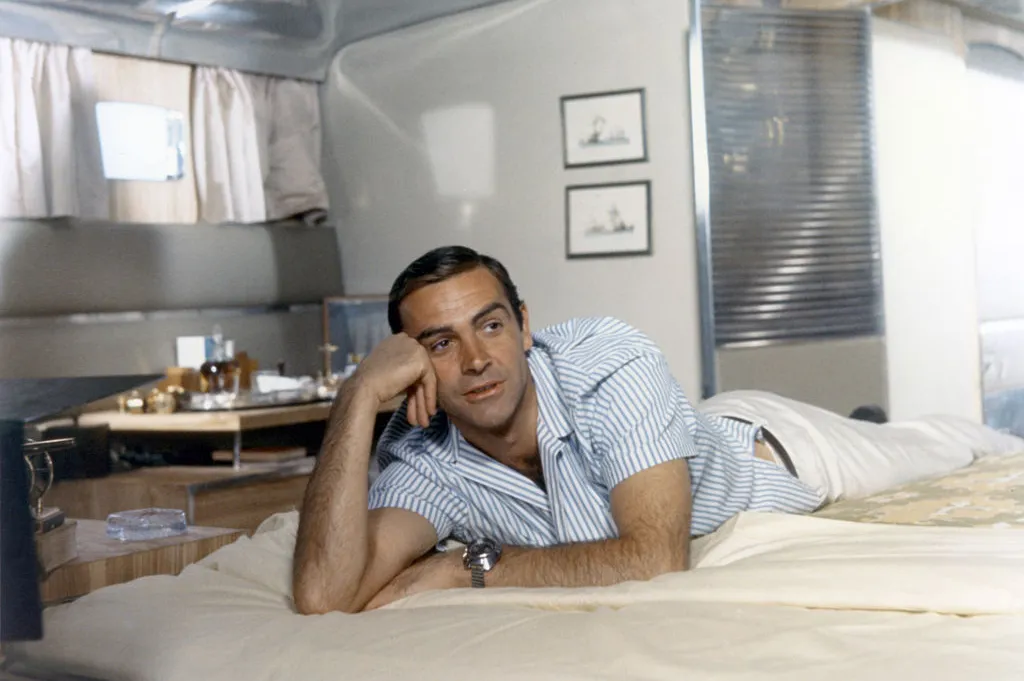 Connery laying on a bed