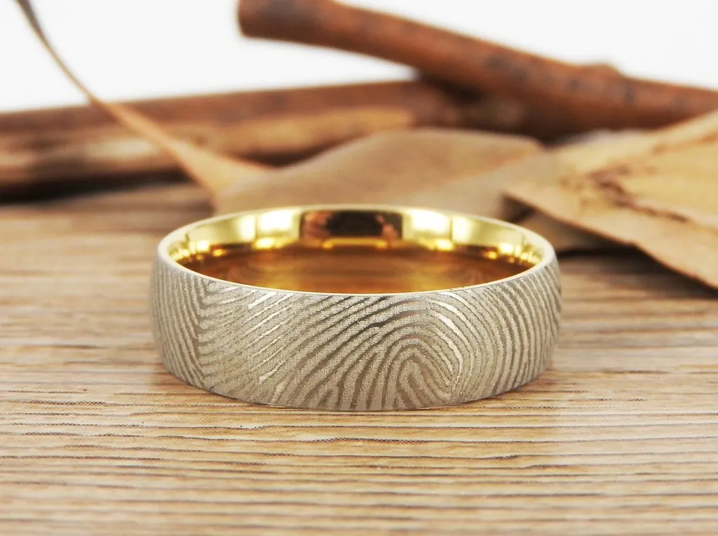 Golden ring with an engraved fingerprint on it