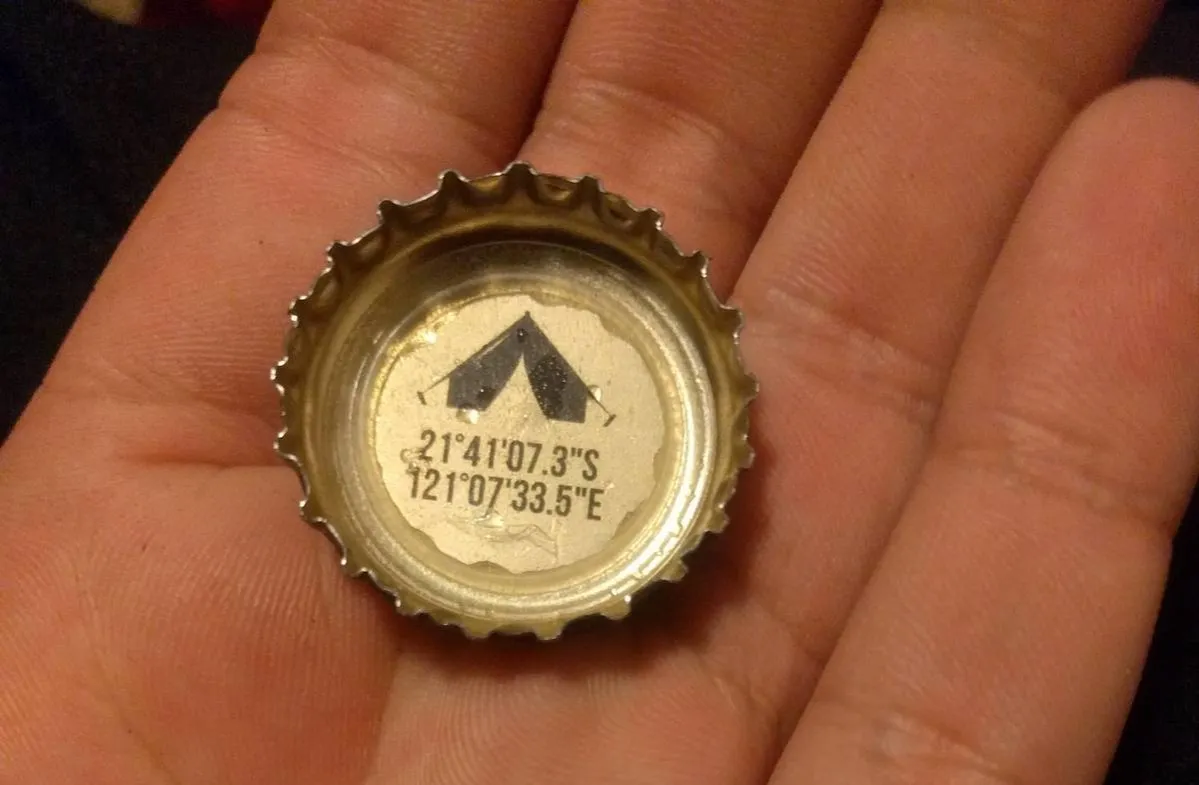 inside of a bottle cap with coordinates to a camp ground