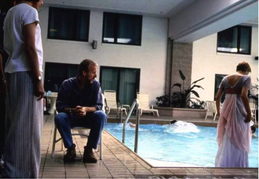 Kate Winslet walks into water during a scene while James Cameron watches behind the scenes