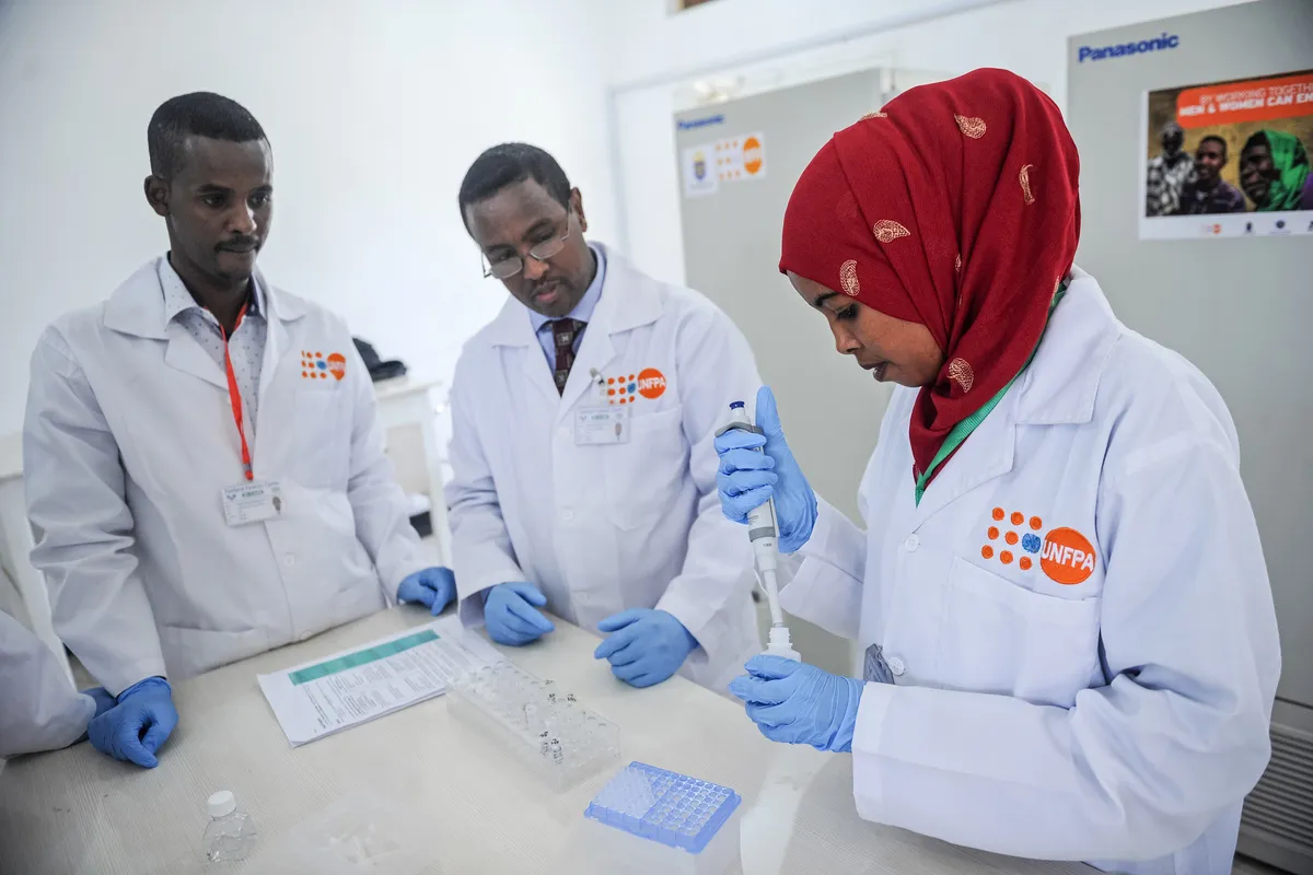 laboratory technicians demonstrating DNA testing at the Puntland Forensic Center in Somalia