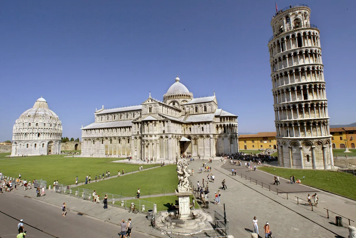 Tourists visit the Leaning Tower of Pisa and the Cathedral in the 