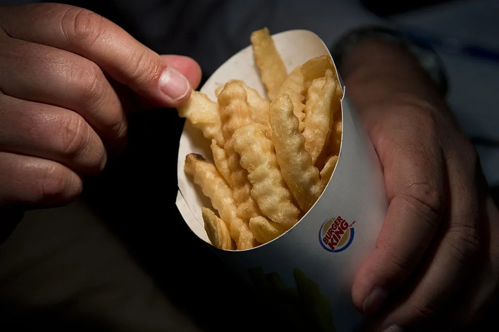 person about to take a fry and eat it