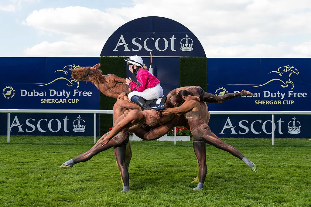 GettyImages-452963820 A team of ten acrobats form the shape of a racehorse crossing the winning post ridden by Stefanie Hofer to celebrate the upcoming Dubai Duty Free Shergar Cup at Ascot Racecourse on July 29, 2014 in Ascot, England. The Dubai Duty Free Shergar Cup is the only team-format raceday in the UK and takes place on 9th August.  