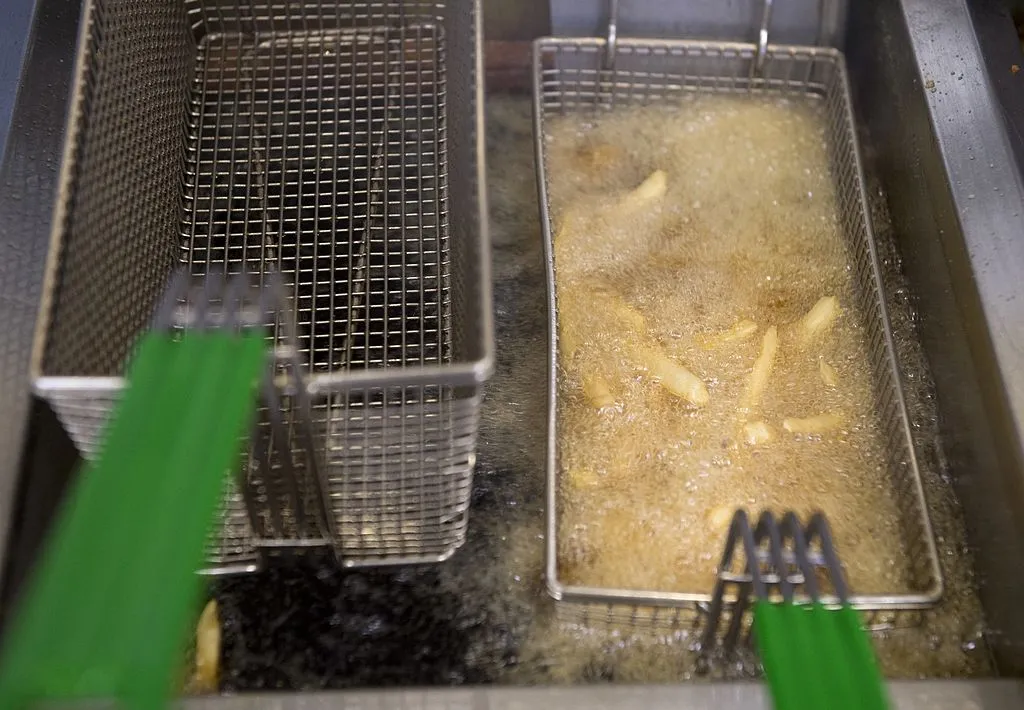 French fries cook in a deep fryer