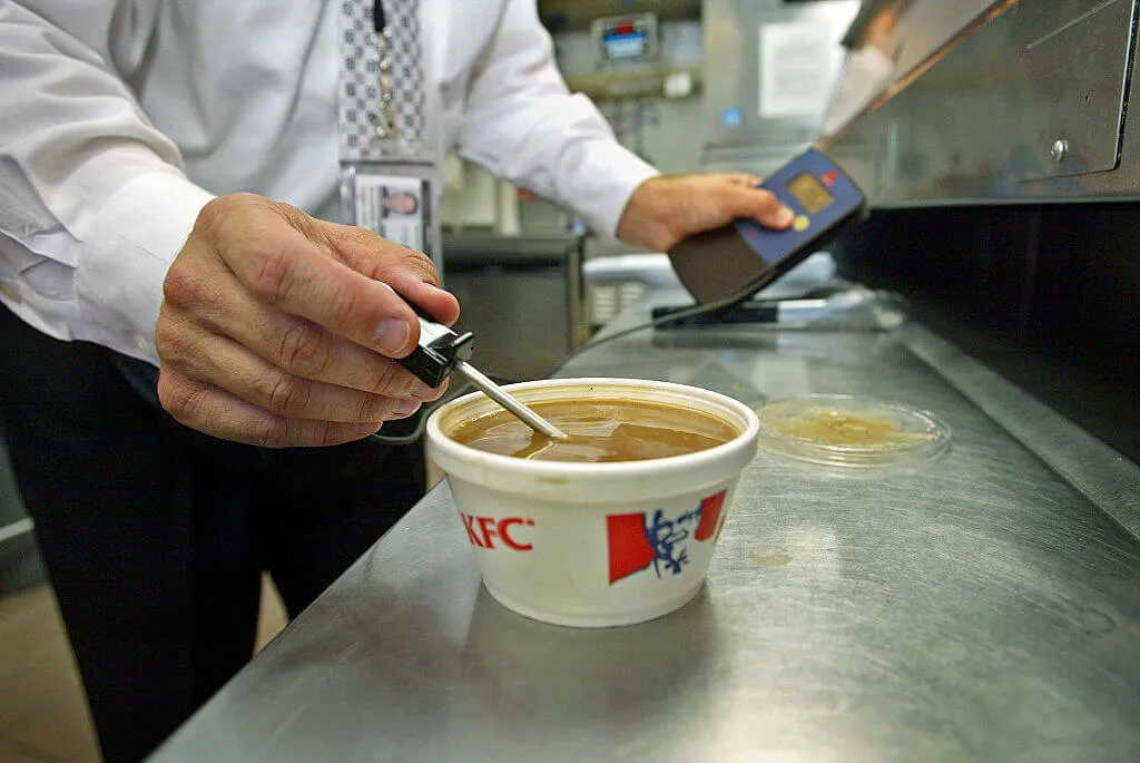 man measuring gravy from kfc