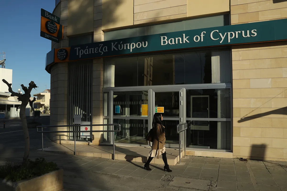  A woman walks past a local branch of Bank of Cyprus on March 5, 2017 in Nicosia, Cyprus.
