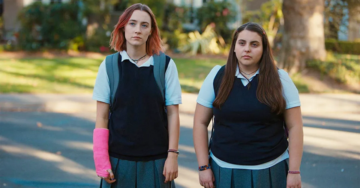 saoirse ronan and beanie feldstein standing on the street in lady bird