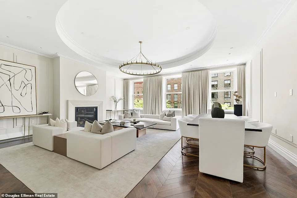 A photgraph of one of the main living room shows white decor in a spacious room