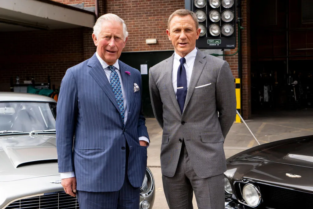 Prince Charles, Prince of Wales poses with British actor Daniel Craig as he tours the set of the 25th James Bond Film at Pinewood Studios