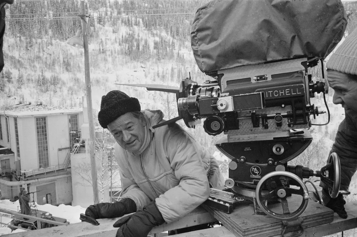 American actor and film director Anthony Mann (1906 - 1967) and a camera operator on the set of war film 'The Heroes of Telemark', Norway, 20th January 1965. 