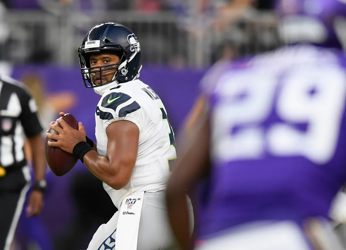 Russell Wilson #3 of the Seattle Seahawks looks to pass the ball against the Minnesota Vikings , 2019