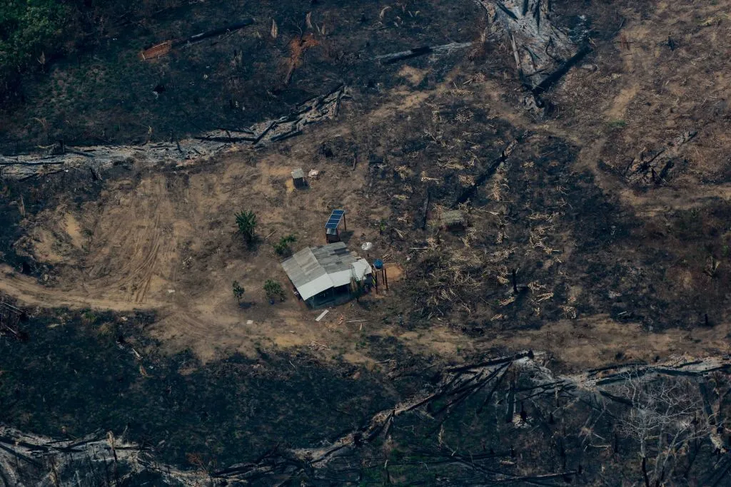 An aerial view shows burned, cleared land surrounding a building in northwestern Brazil.