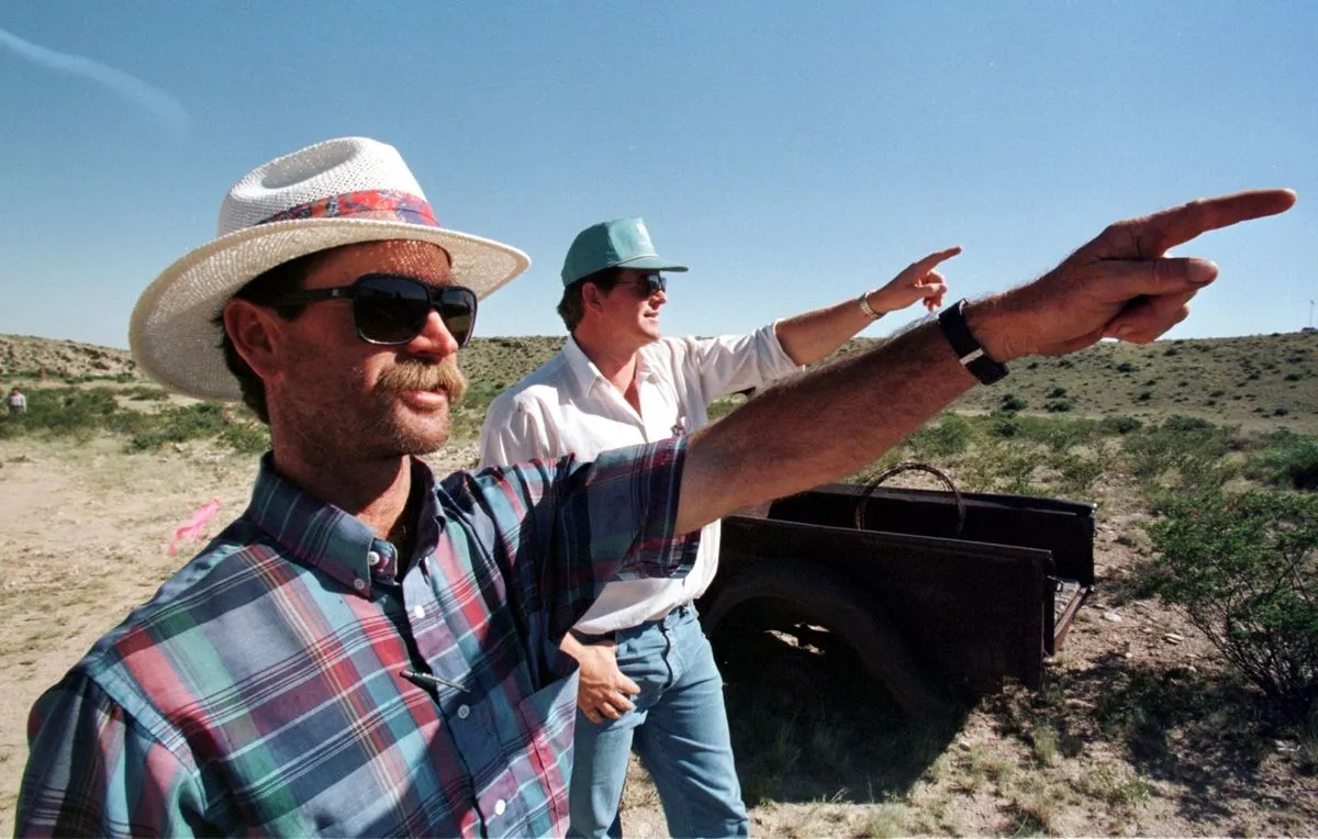 David Corn (L) and his cousin Bill Marley point toward the direction from where the alleged UFO came, before crashing at his ranch 50 years ago in Roswell, New Mexico.