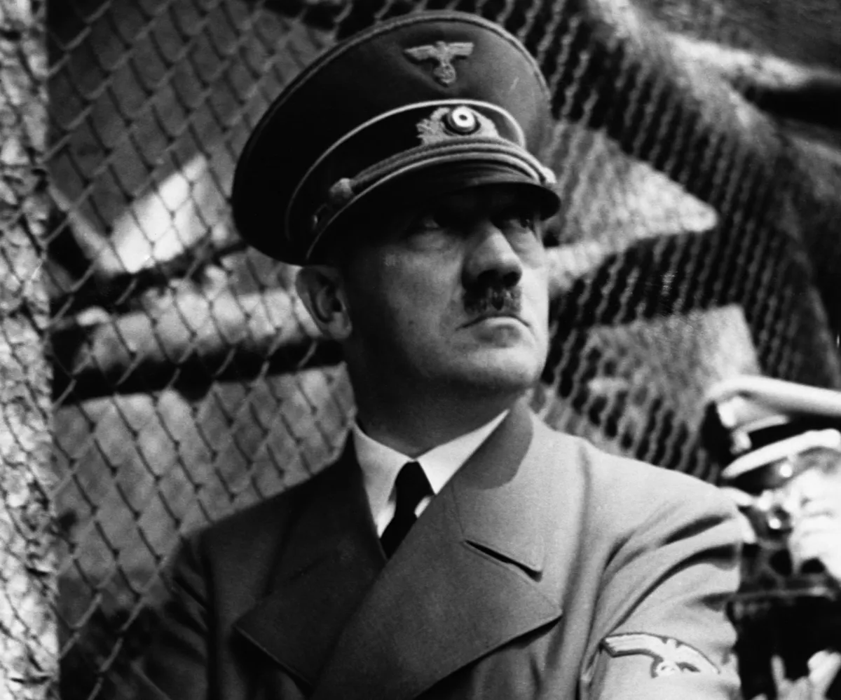 Nazi dictator Adolph Hitler in front of zoo cage.
