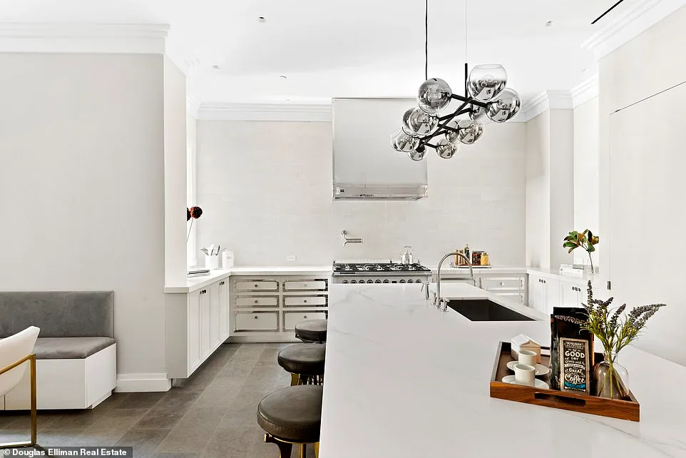 The kitchen's island is lined with barstools in front of a large stove and surrounding cabinetry.