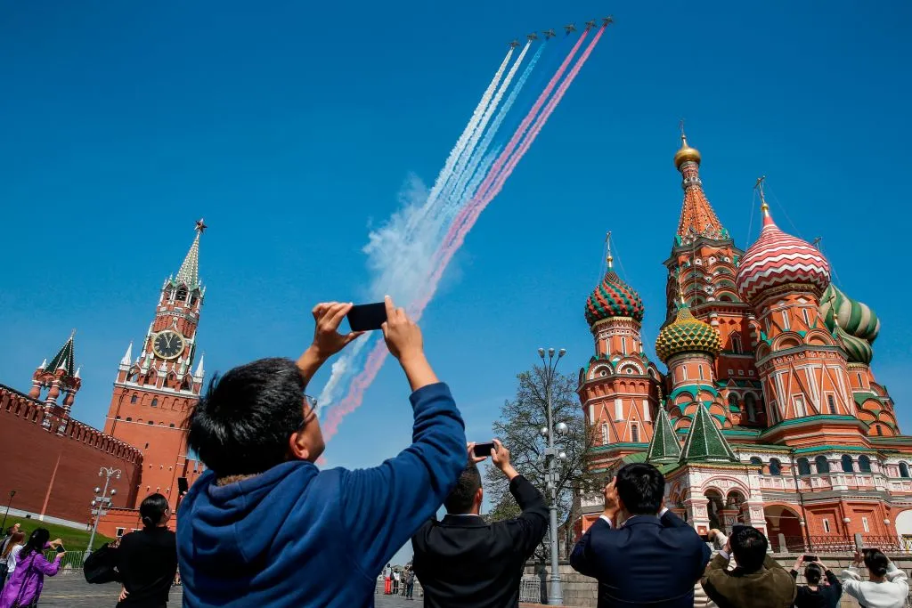 Russian aircrafts fly over Red Square releasing colors of the Russian flag