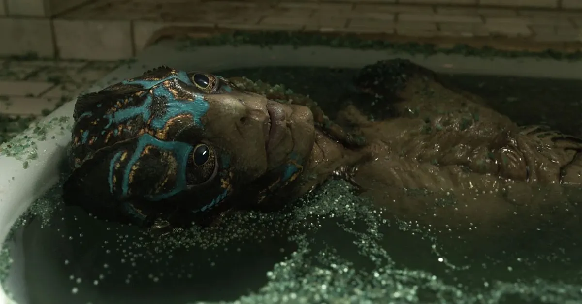 doug jones as the amphibian man in the shape of water. he's laying in a bathtub