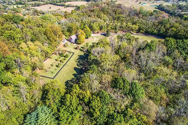 An aerial view shows the property and its surrounding 36 acres of land