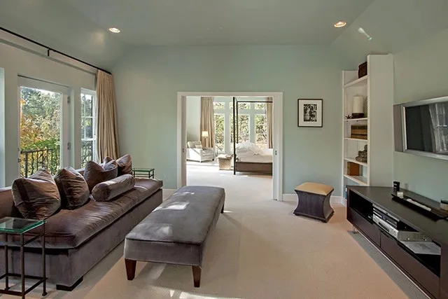 A large seating area leads into the master bedroom