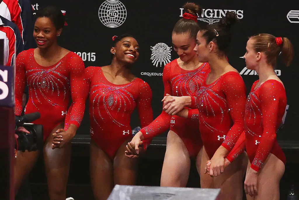 simone biles in a crowded group of athletes