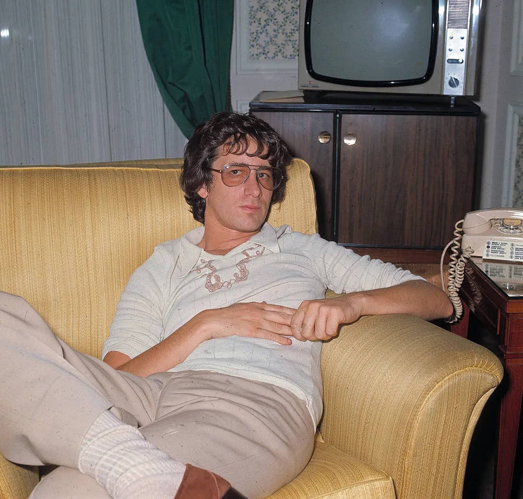 The American scriptwriter and movie producer Steven Spielberg sitting on his sofa. 1975