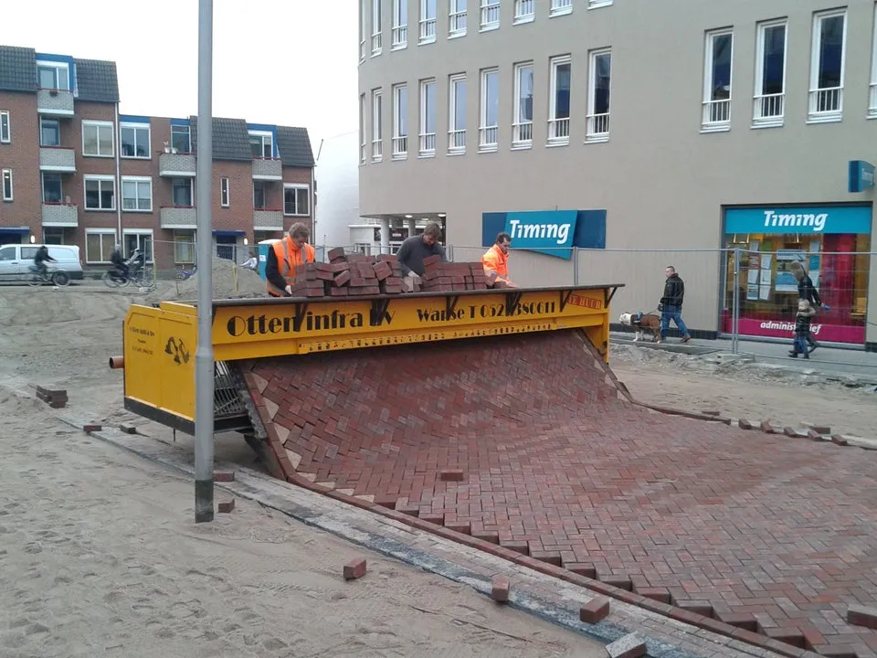machine laying bricks for a road in the netherlands