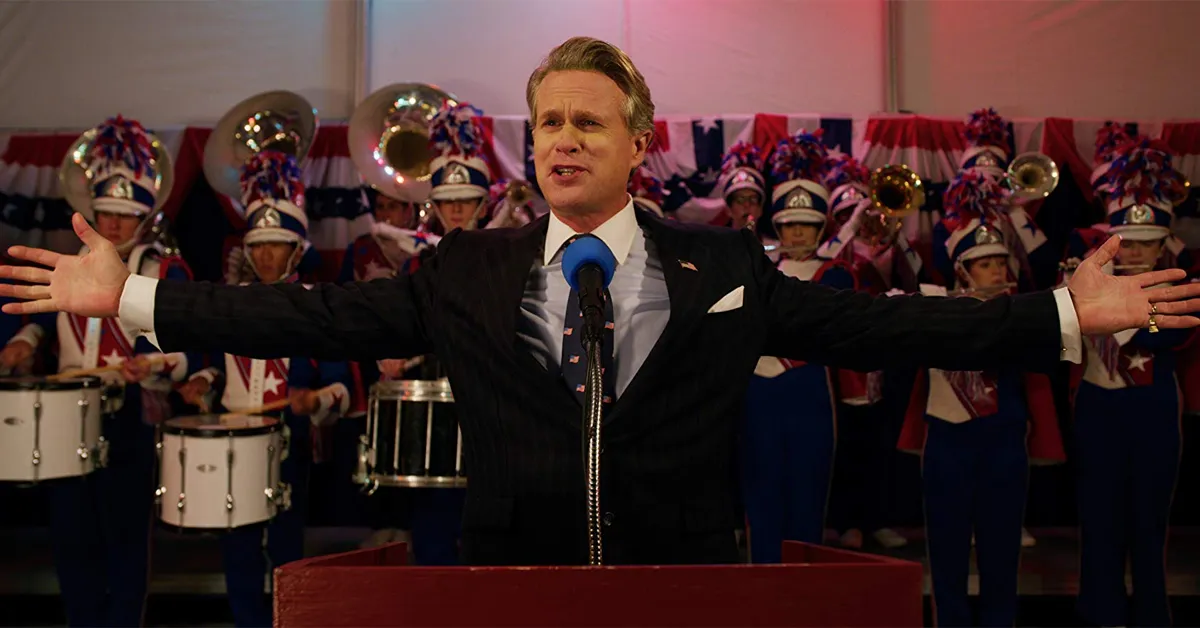 cary elwes standing in front of a marching band