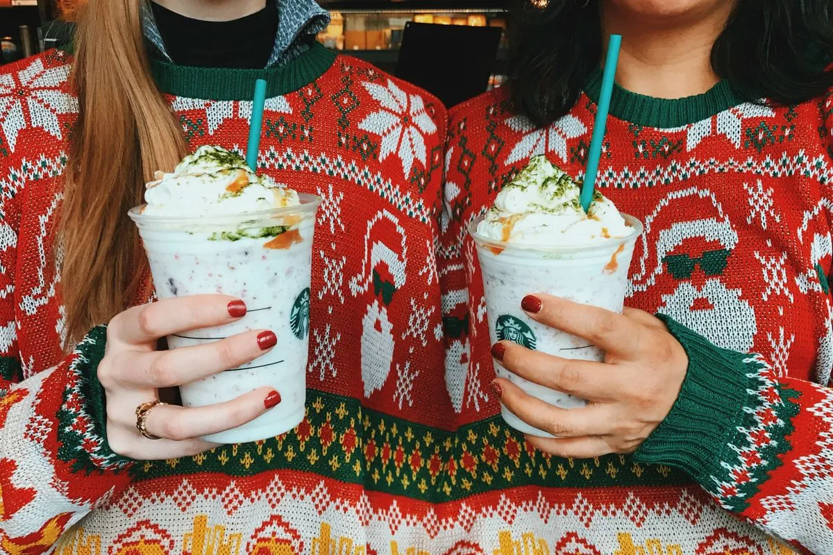 fans holding a fruitcake frappuccino