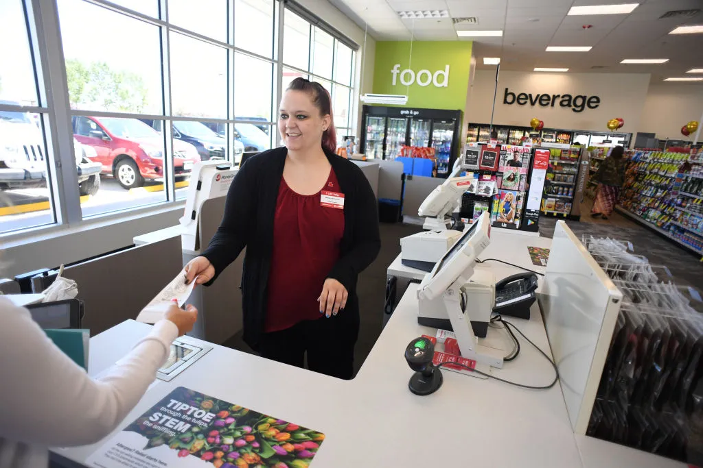 Melissa Bendever, of CVS Pharmacy, helps a shoppers