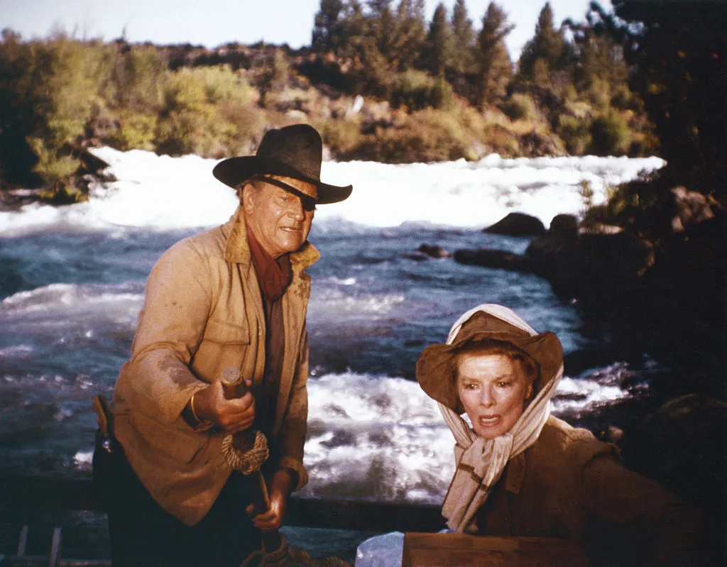 American actors John Wayne and Katharine Hepburn on the set of Rooster Cogburn