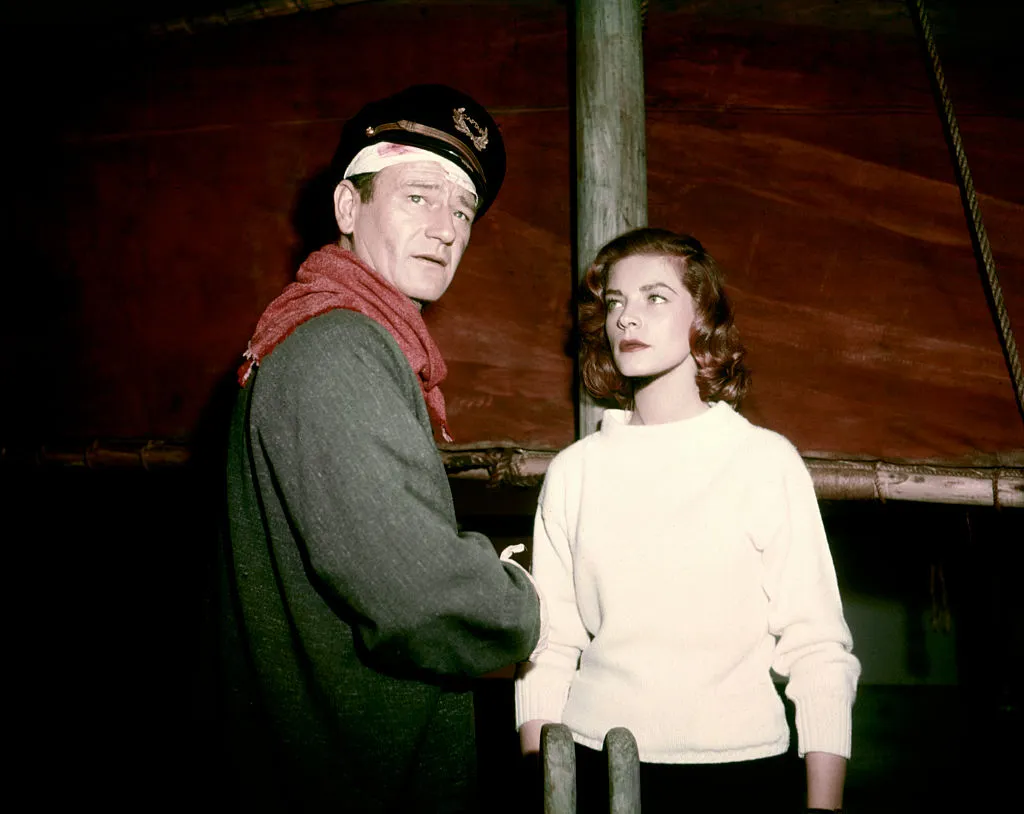 American actors John Wayne and Lauren Bacall on the set of Blood Alley, based on the novel by Albert Sidney Fleischman