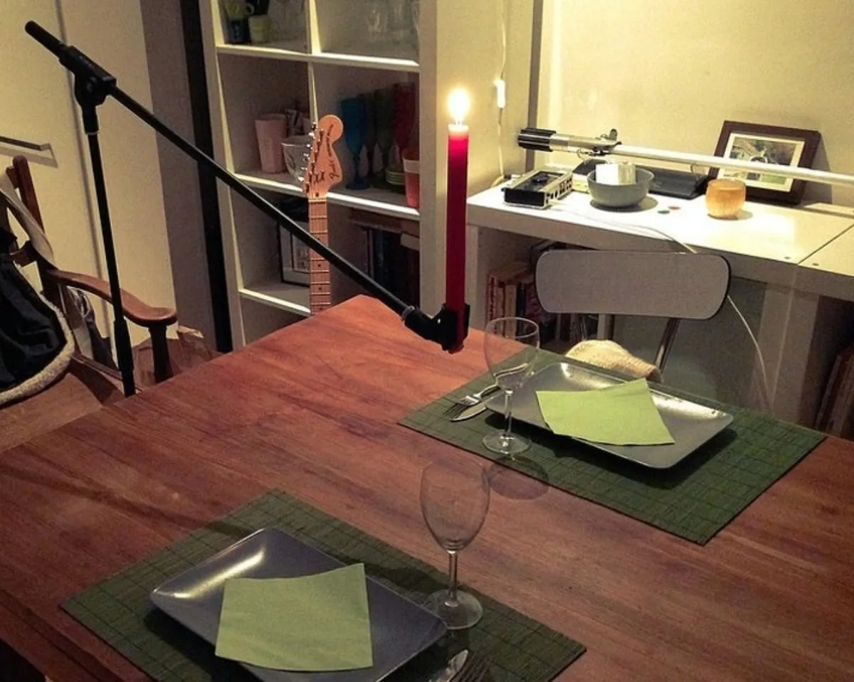 person uses mic stand as a candle holder FOR DINNER