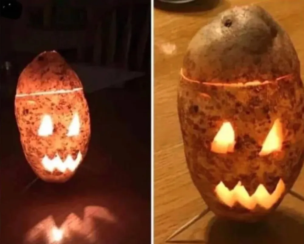 person carves potato into jack o lantern