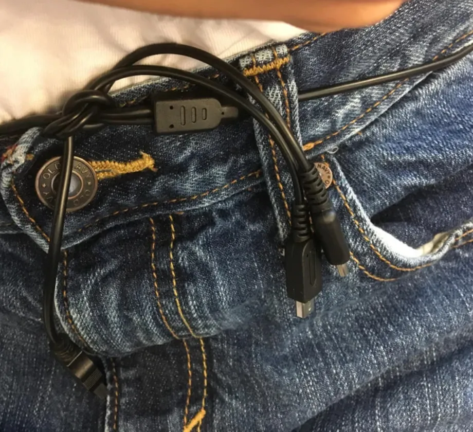 Person uses charging cord as belt